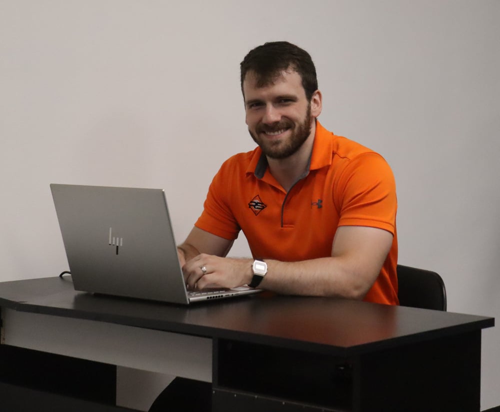 Rock Solid physical therapist seated at a desk with a laptop Rock Solid physical therapist seated at a desk with a laptop